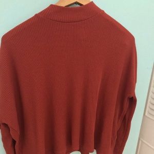 Orangey red, long sleeve, short turtle neck